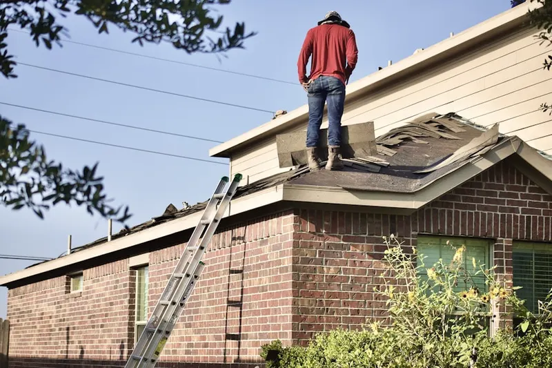 Professional roofer working on a residential roof in Haines Corners